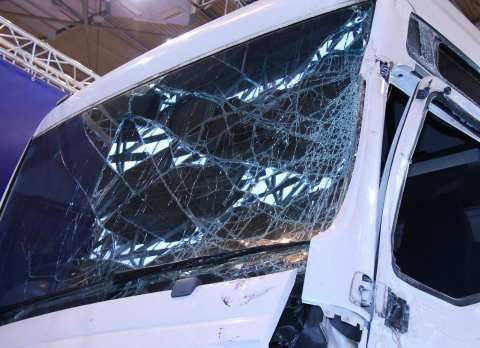A white truck with a broken windshield and door