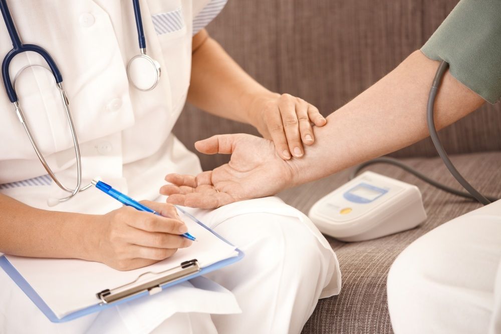 Personal Nurse Checking the Arm of a Patient — Universal Nurse in Blackbutt North, QLD