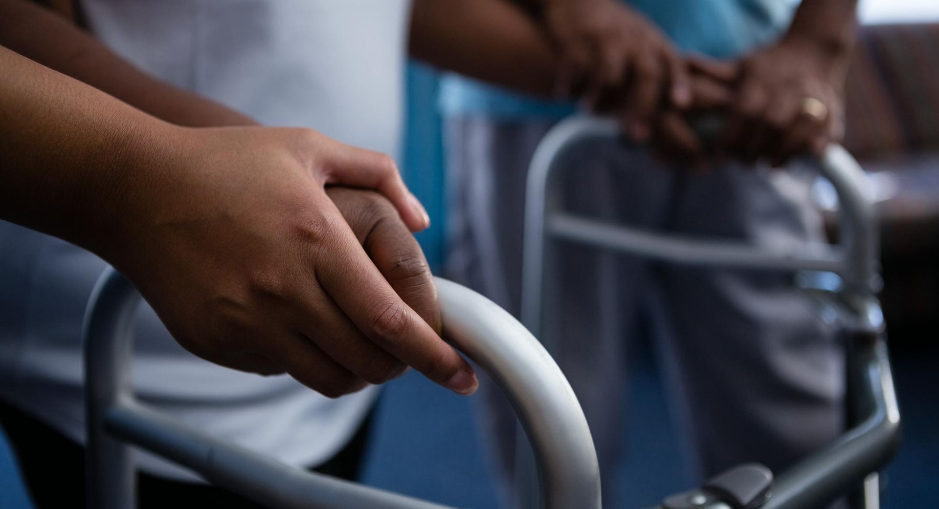 Nurse is Helping a Patient Use a Walker — Universal Nurse in Blackbutt North, QLD
