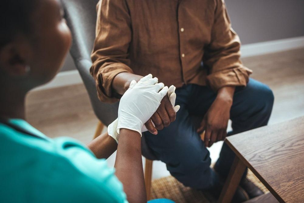 Nurse is Wrapping a Patient Wrist With a Bandage — Universal Nurse in Blackbutt North, QLD