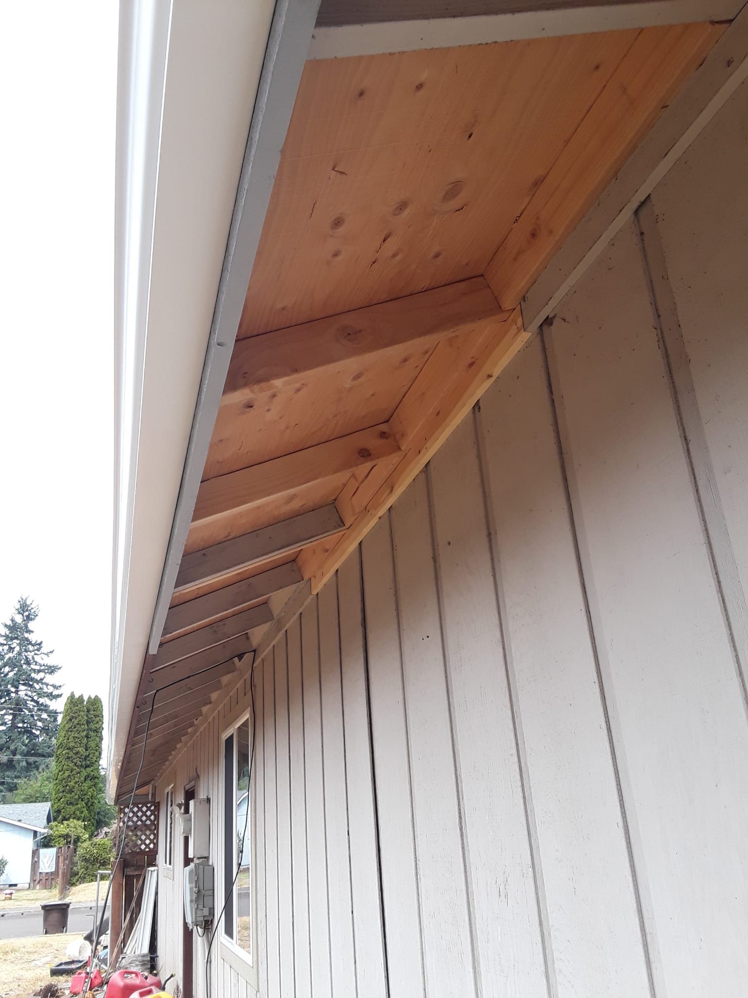a white house with a wooden roof and a window .