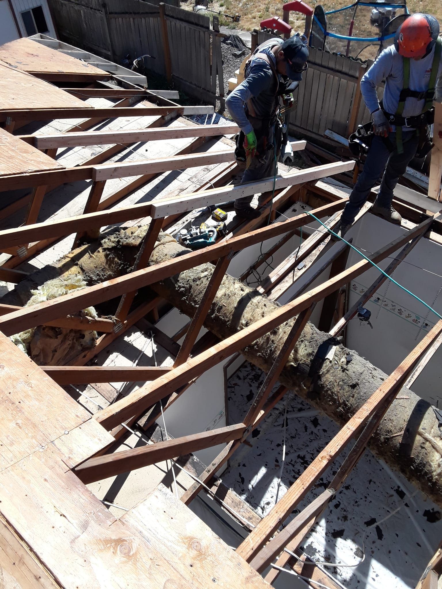 a group of construction workers are working on a wooden structure