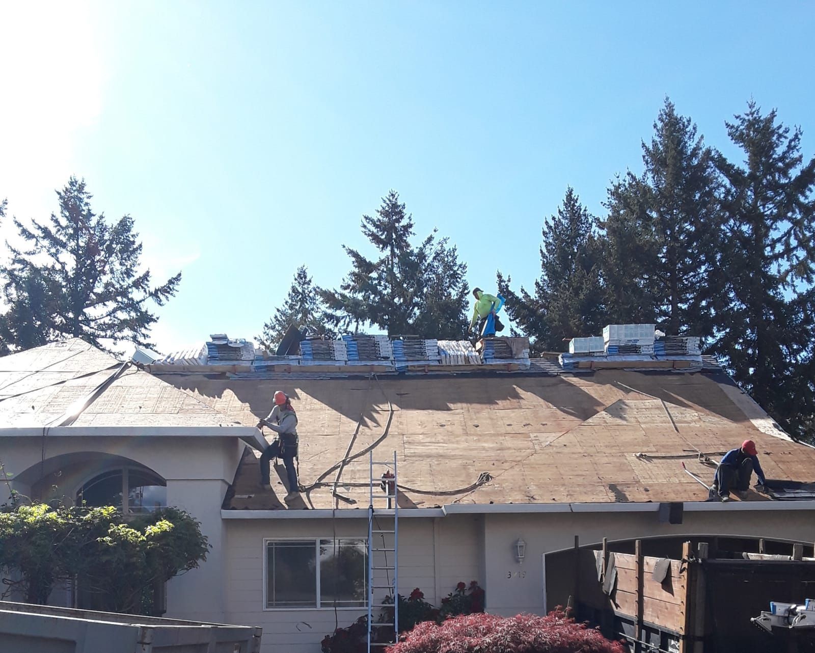 a man is working on the roof of a house