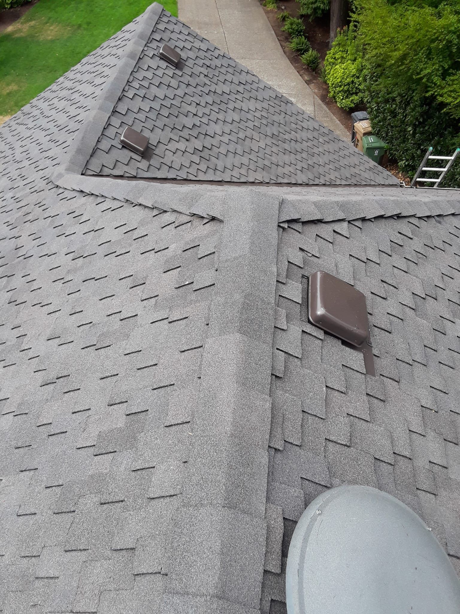 an aerial view of a roof with a ladder in the background