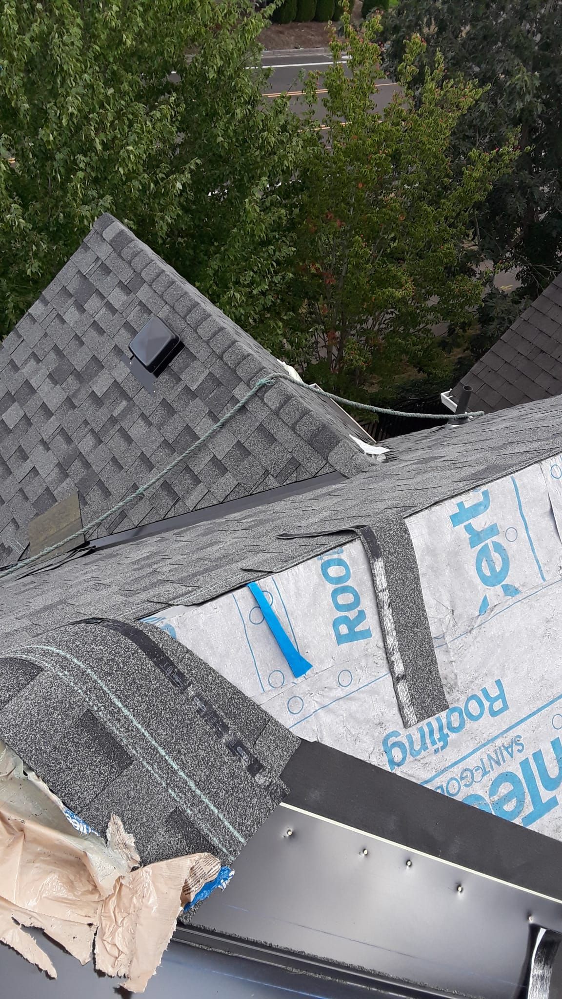a roof with shingles being installed on it .