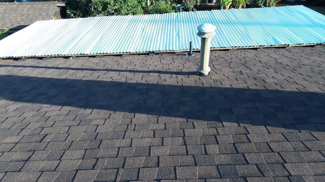 a roof with a blue tarp on top of it