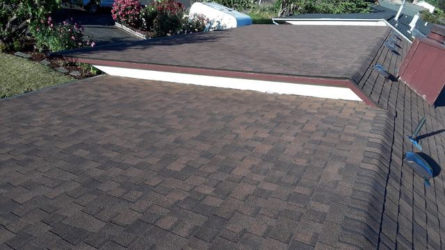 a brick driveway with a roof in the background .