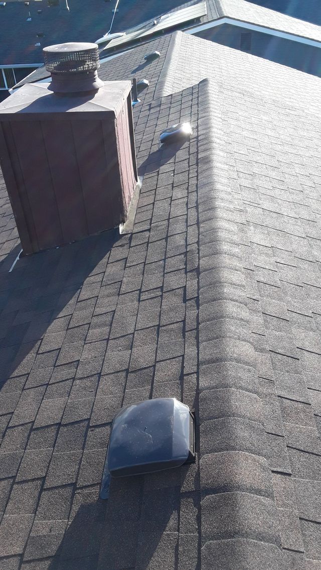 a roof with a chimney and a light on it