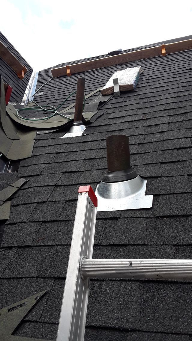 a ladder is sitting on top of a roof .