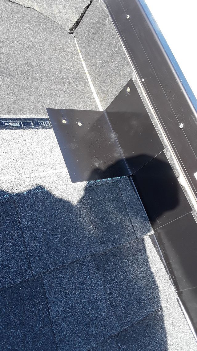 a close up of a roof with a shadow of a person on it .