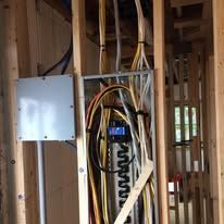 A bunch of wires are hanging from the ceiling of a building.