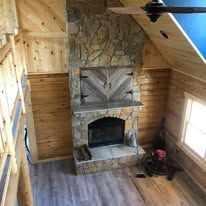 There is a fireplace in the middle of the room.