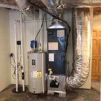 There is a water heater and an air conditioner in the basement.