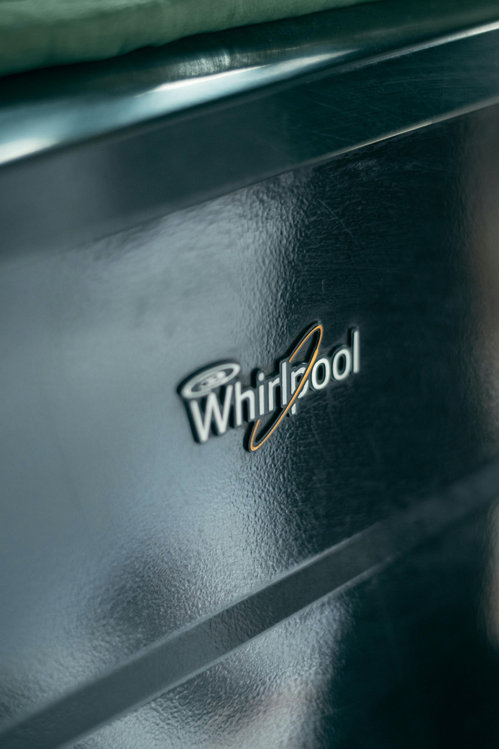 Whirlpool logo on a dark, glossy appliance panel.