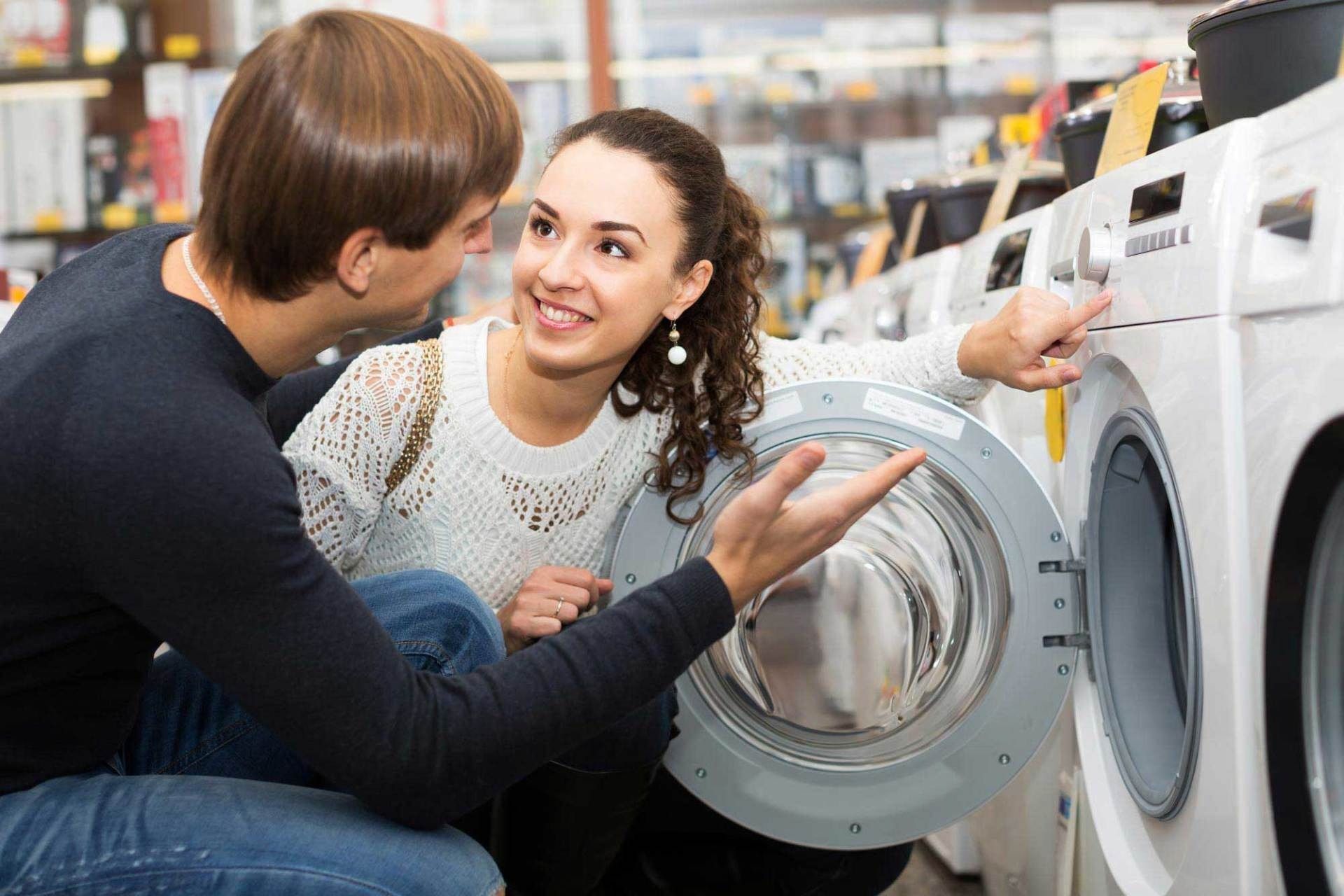Couple Looking At Washing Machine — The Latest Home Appliances in Rockhampton