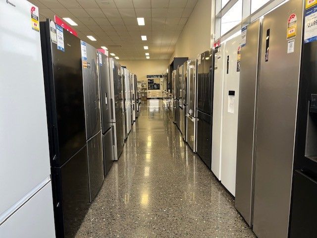 A Row of White Refrigerators are Lined up in a Store — The Latest Home Appliances in Rockhampton