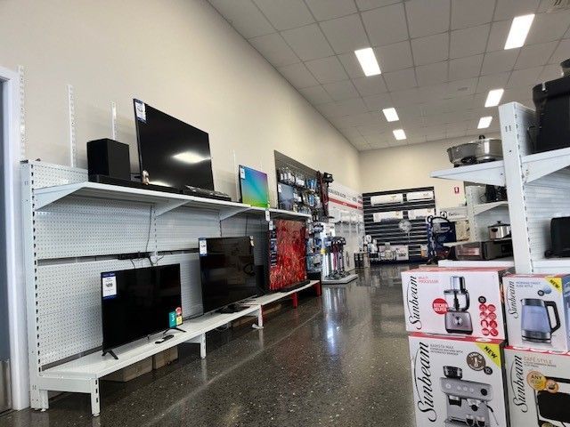 Sales man Showing a Washing Machine — The Latest Home Appliances in Rockhampton
