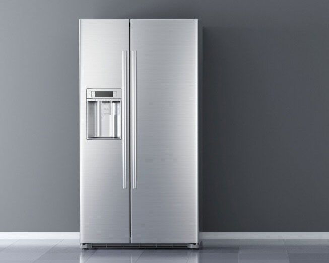 A Stainless steel Refrigerator is Sitting in front of a gray wall — The Latest Home Appliances in Rockhampton