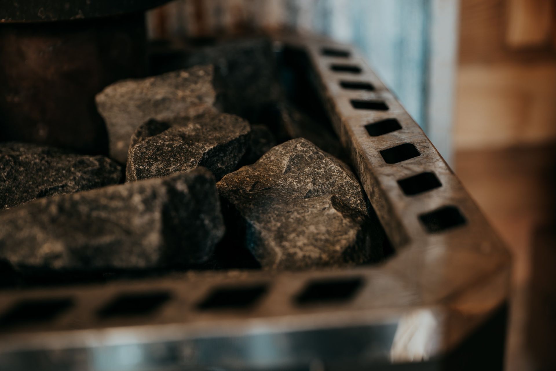 A close up of a stove with rocks in it.