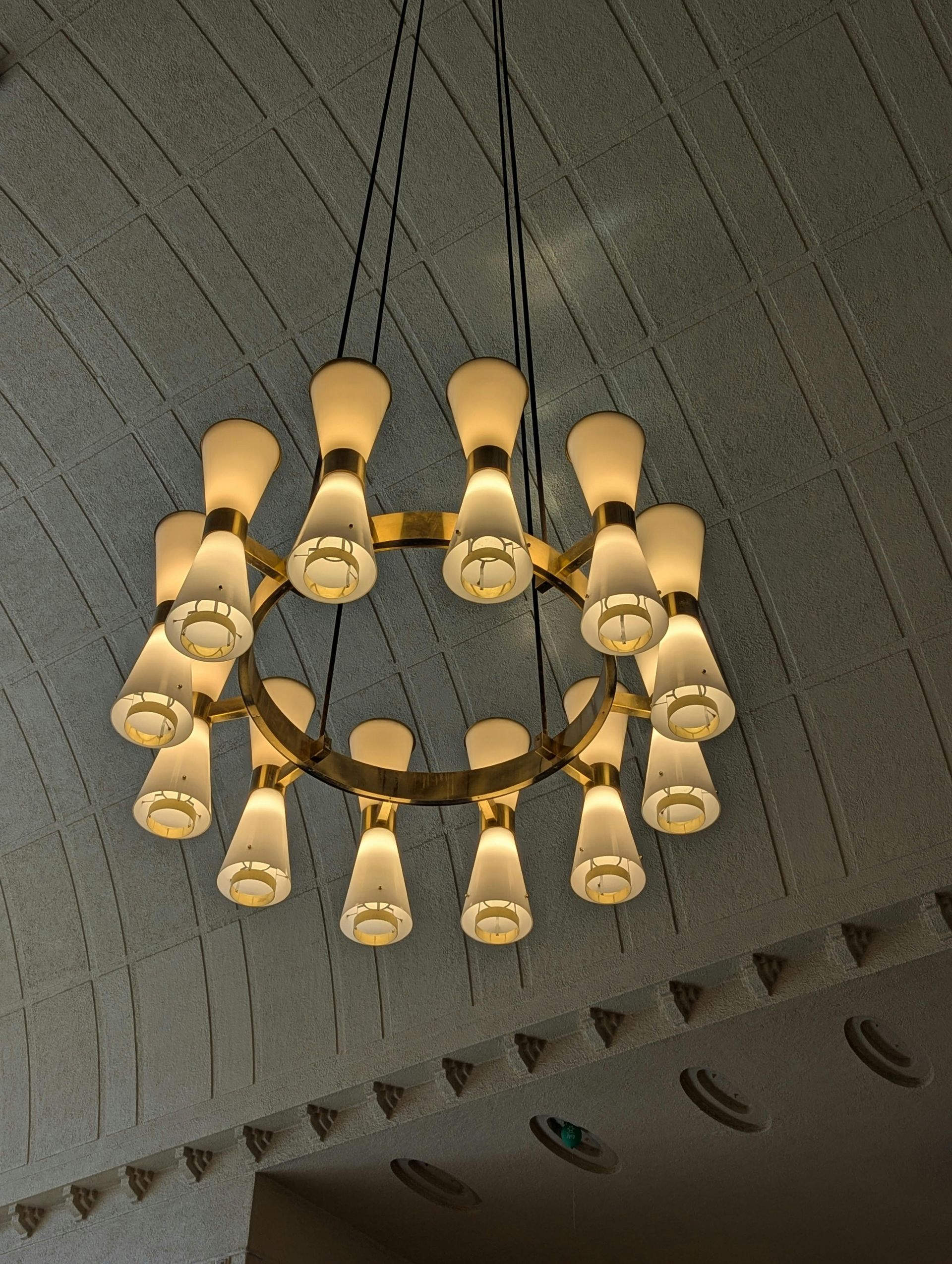 A chandelier is hanging from the ceiling in a room