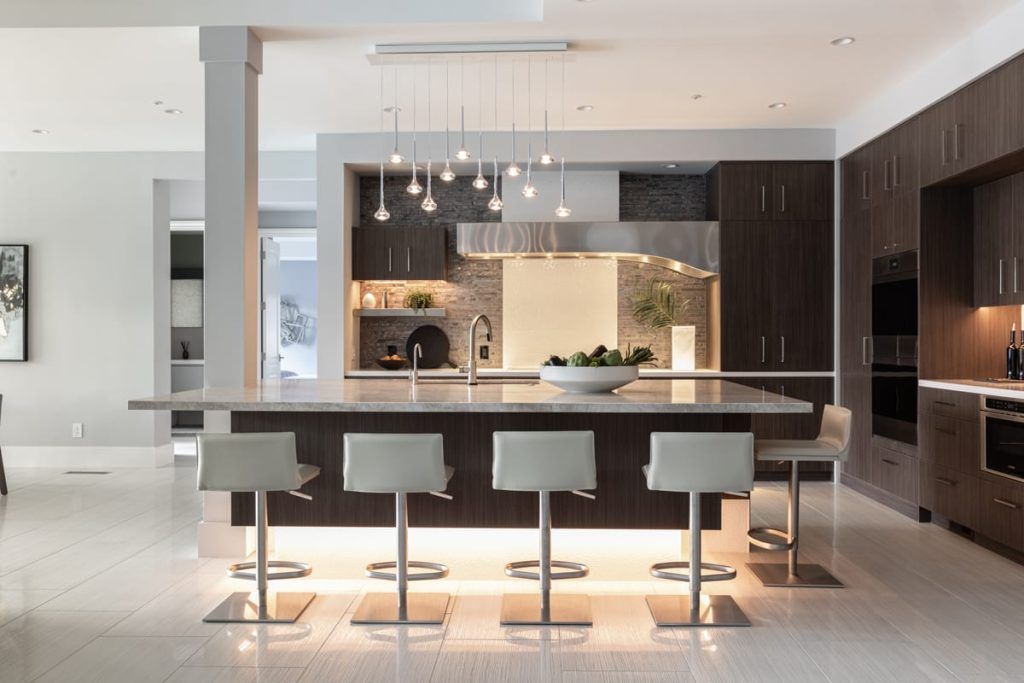 A kitchen with a large island and stools