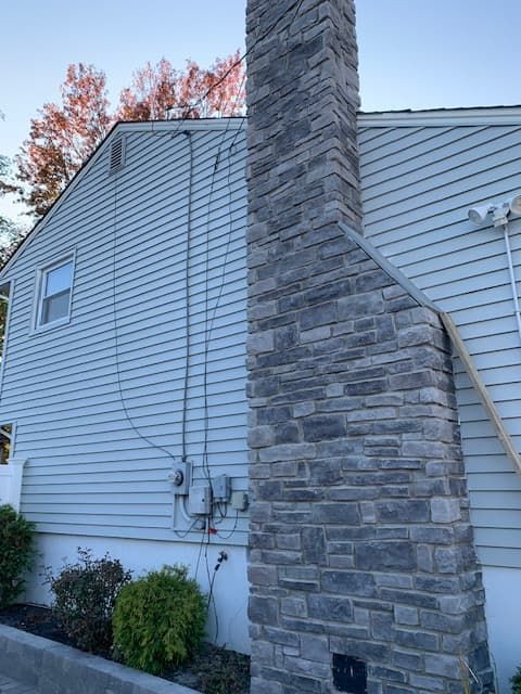 A house with a chimney on the side of it