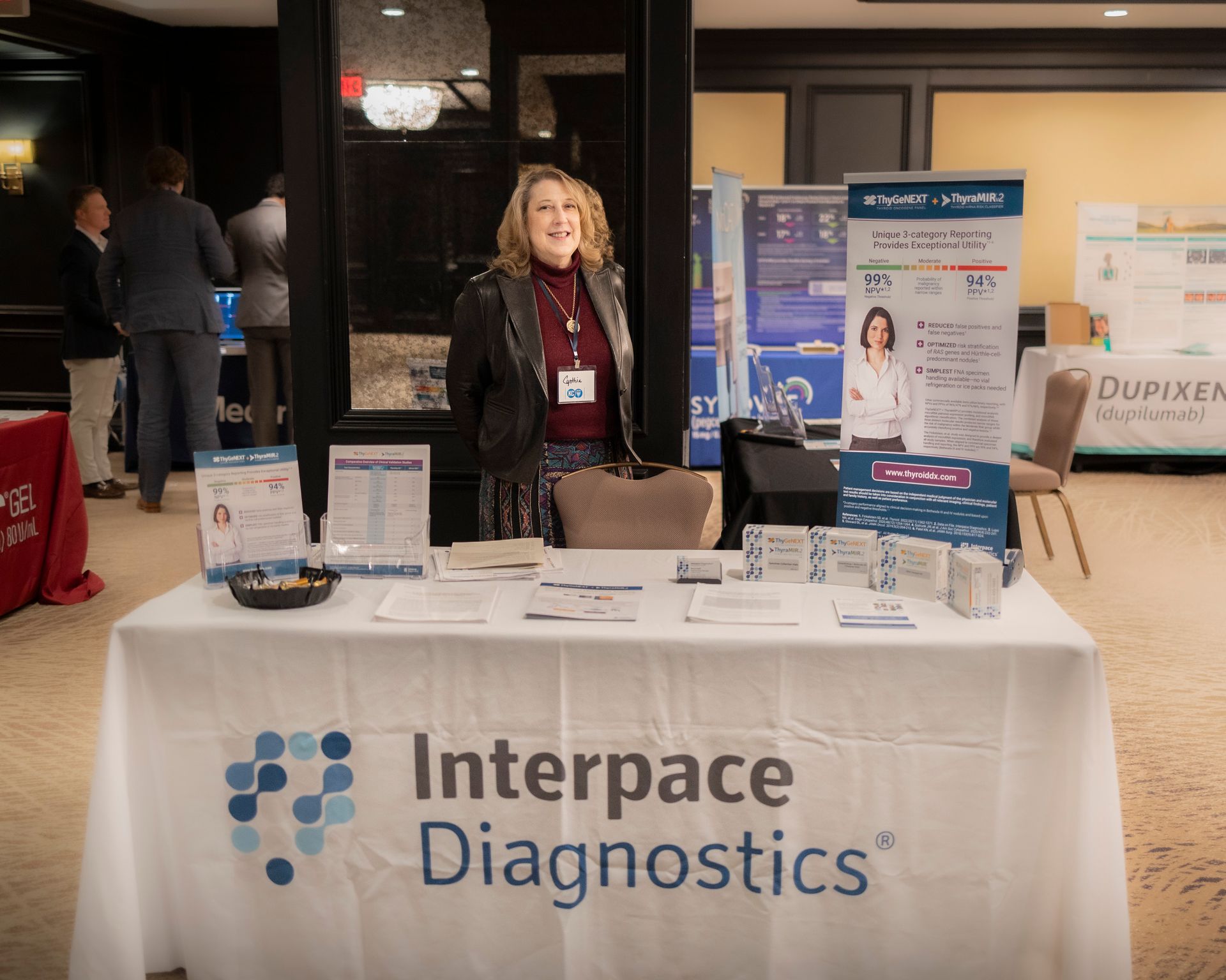 A woman is standing in front of a table that says interspace diagnostics.