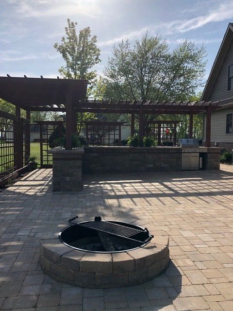 Hardscape patio and retaining wall installation by Harkins Unique Landscapes