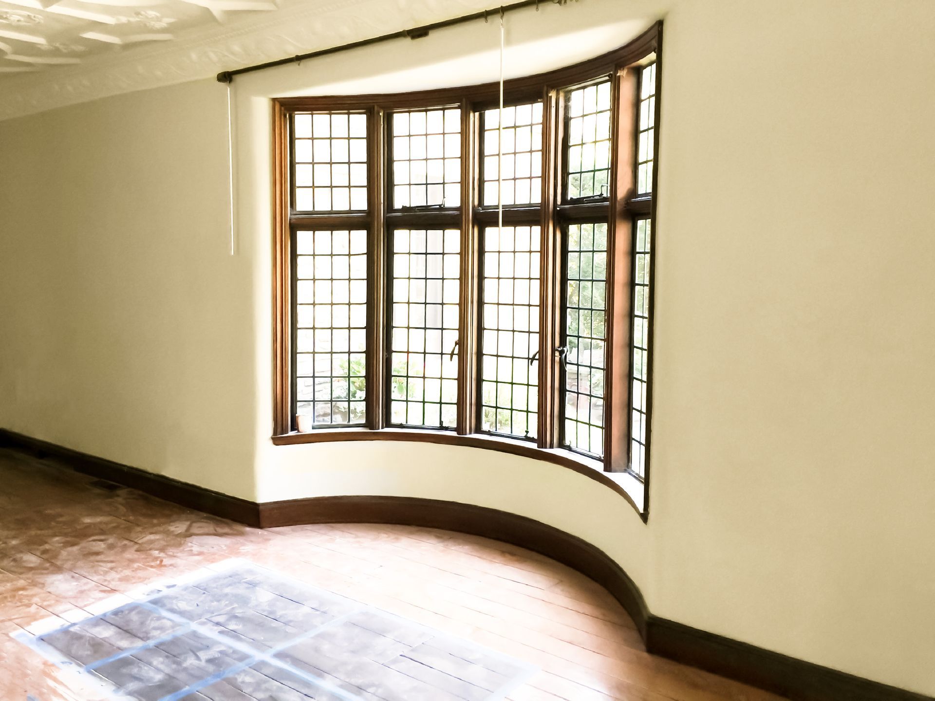 An empty room with a large curved window