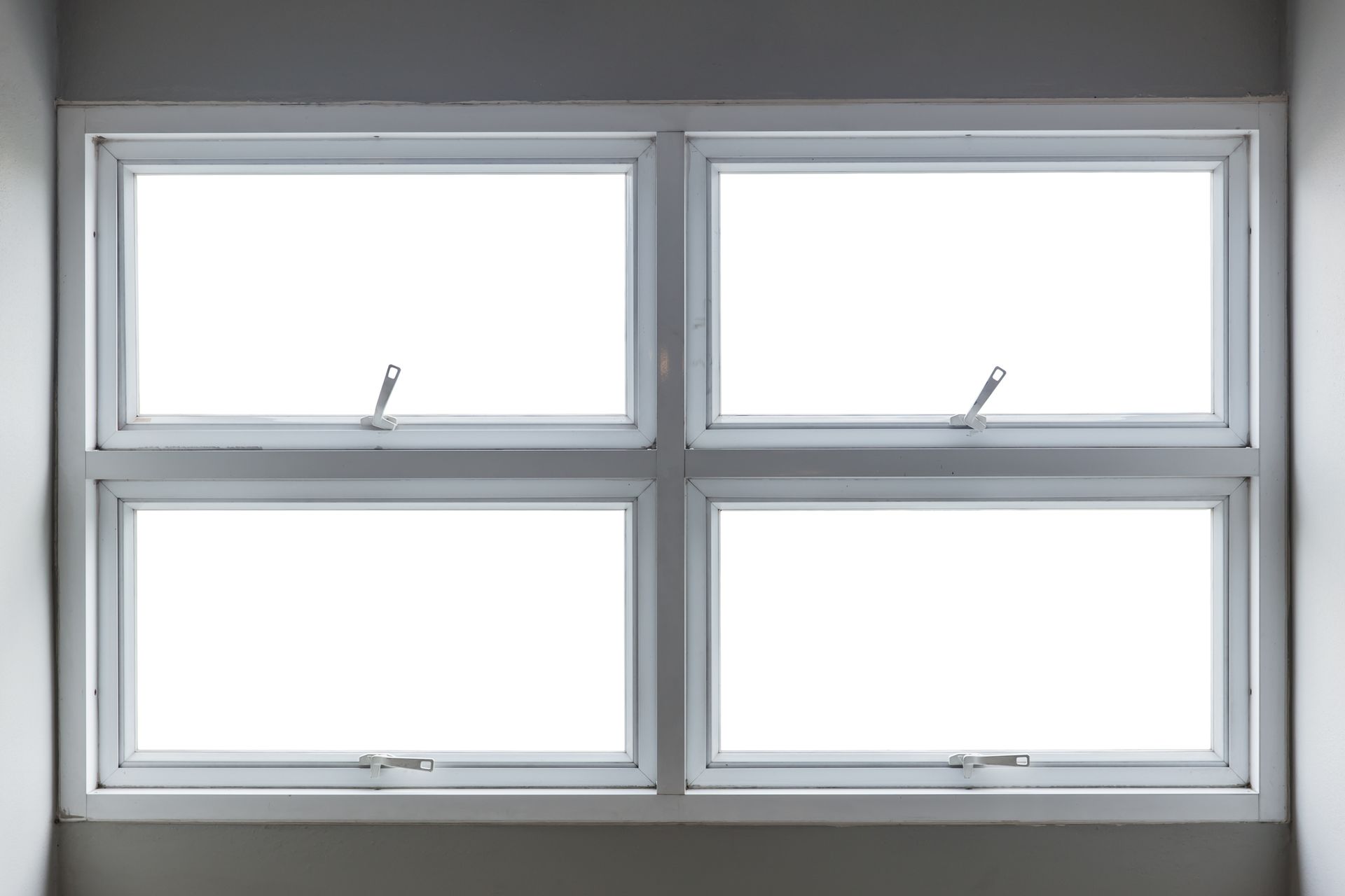 There are four windows in the room with white frames.