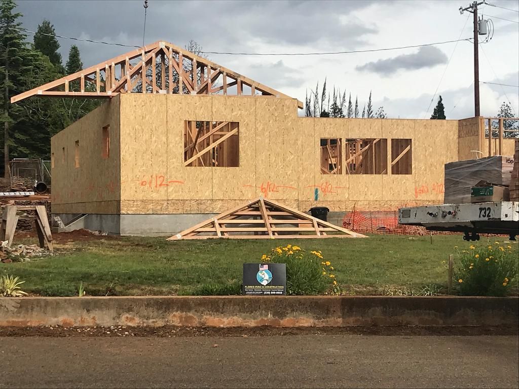A house is being built on a lush green field