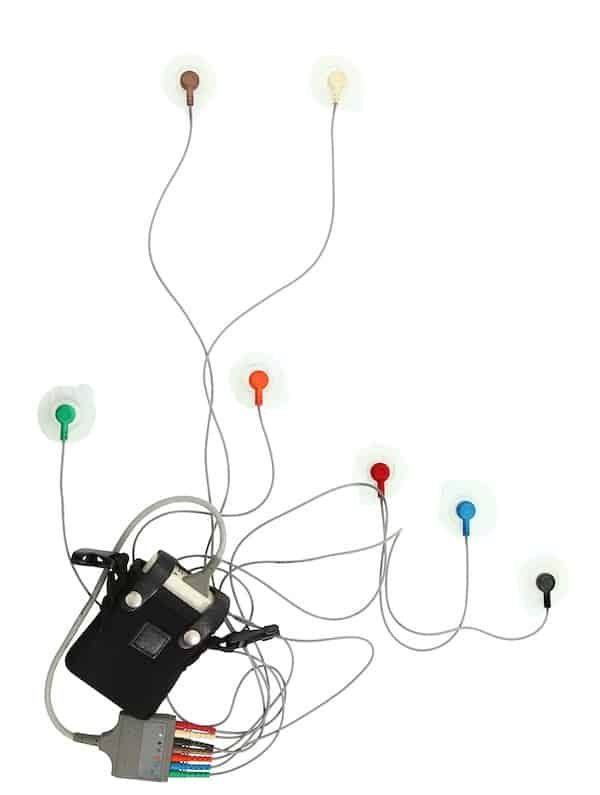 ECG machine with colored electrode wires and a black monitoring device.