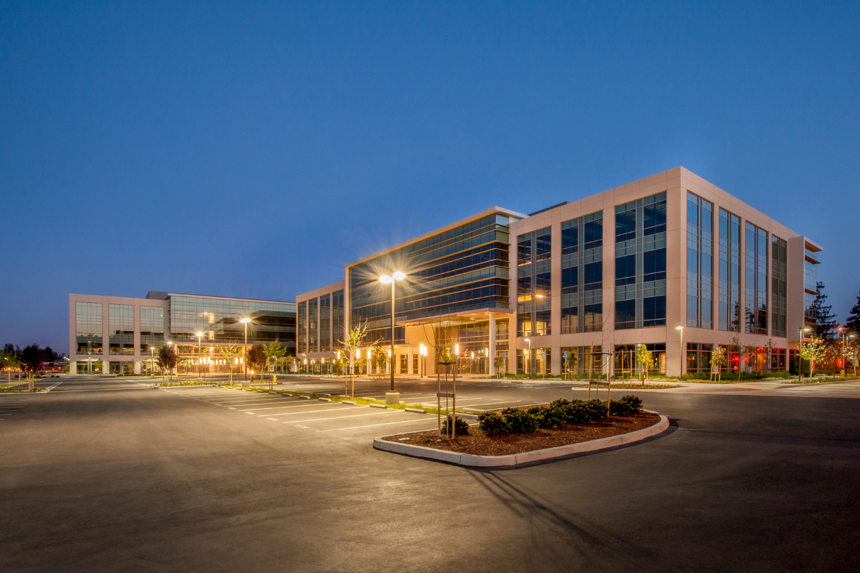 A large building with a lot of windows is lit up at night