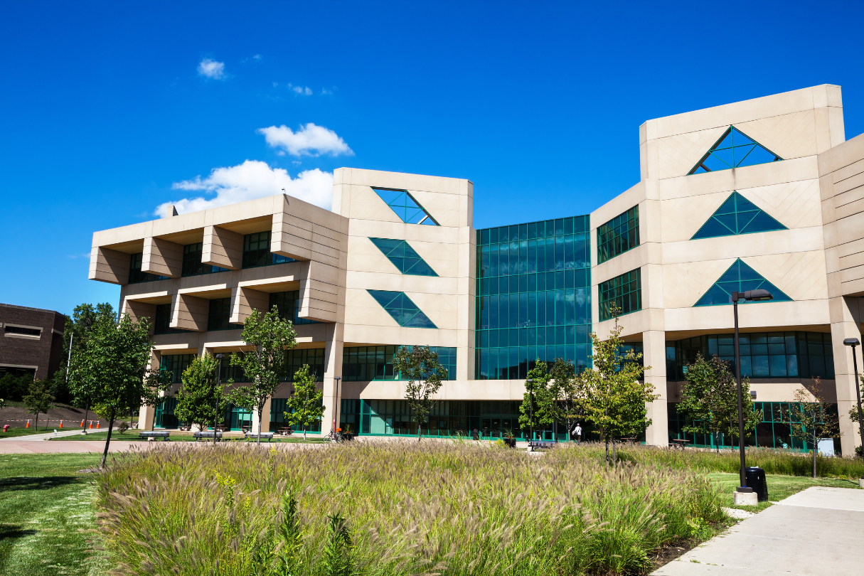 A large building with a lot of windows and trees in front of it