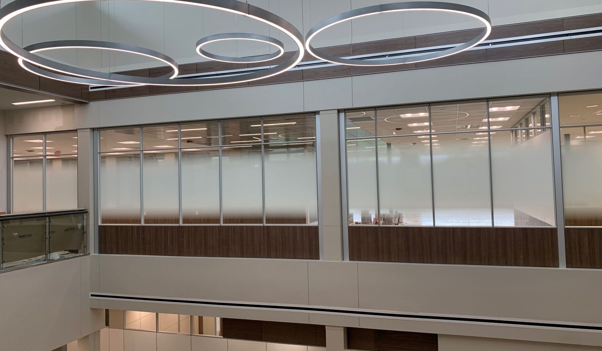 A large room with a lot of windows and a ceiling light.