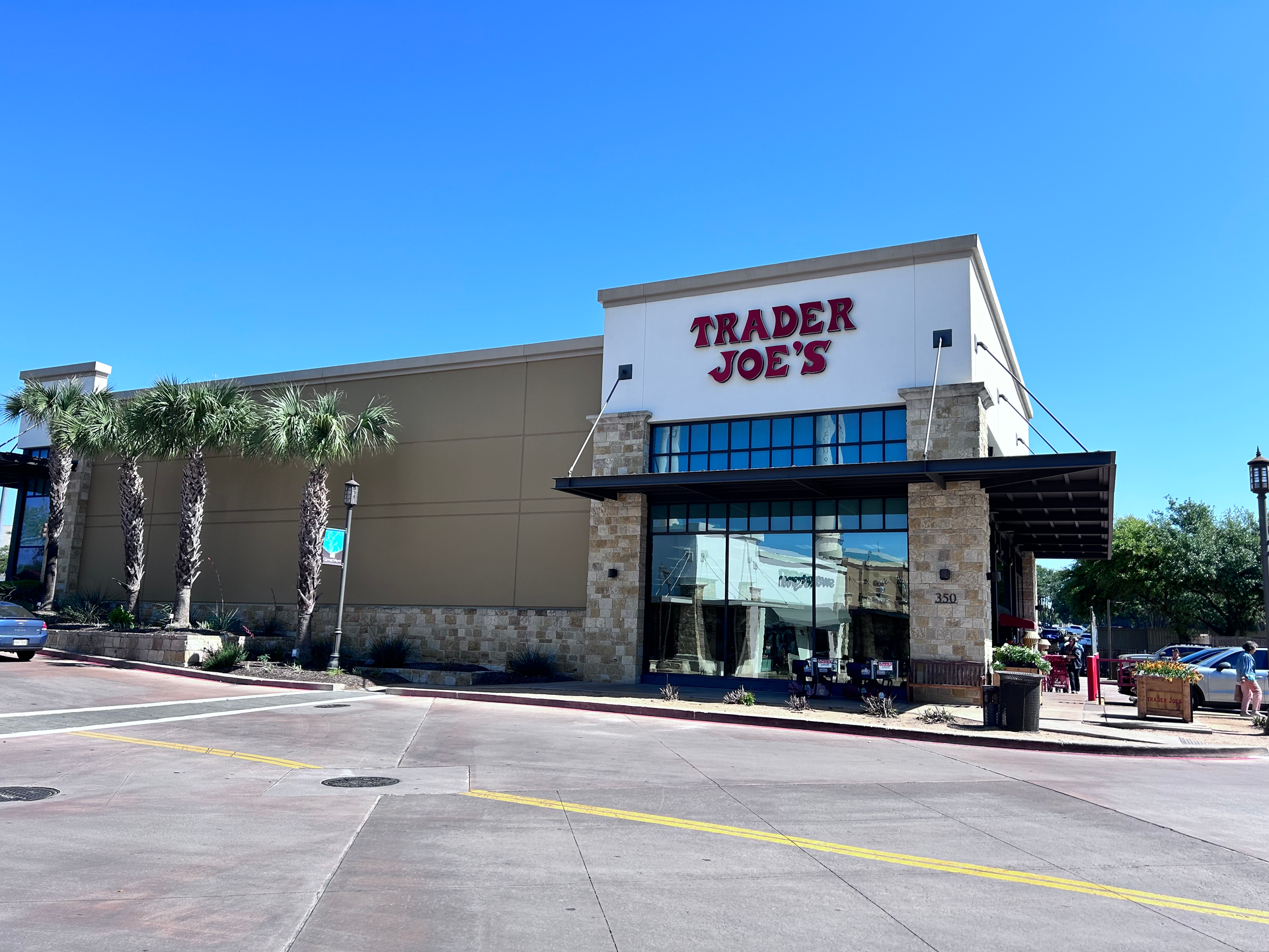Trader joe 's is located on the corner of a street