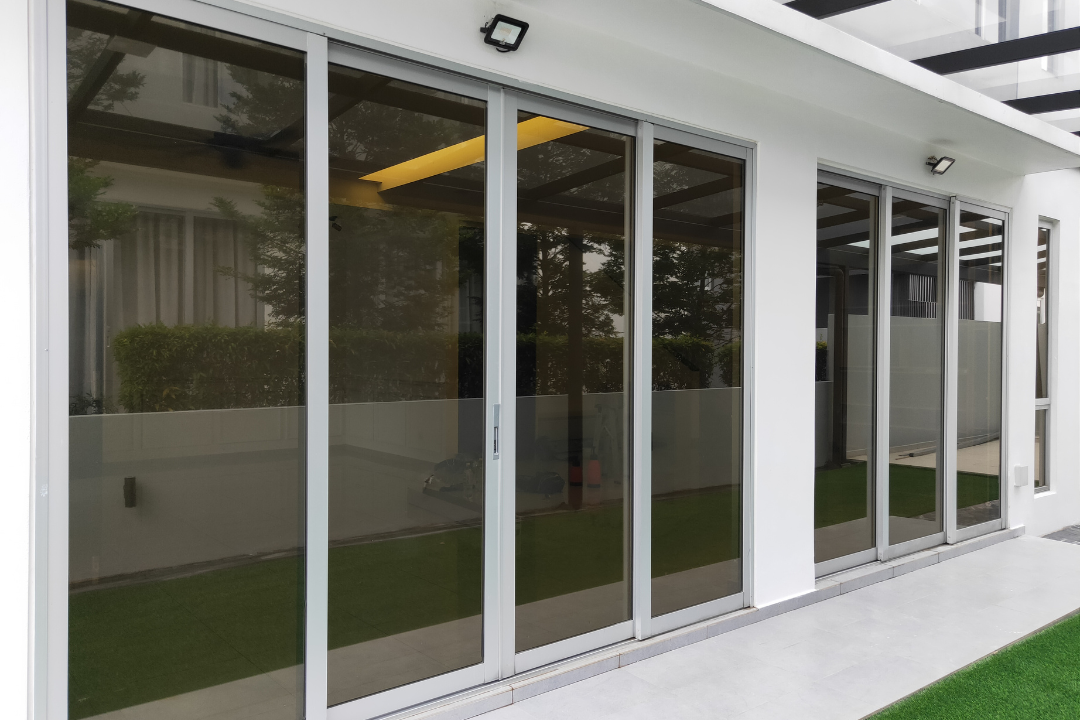 A glass sliding door with a white wall, featuring privacy film, located in a San Antonio setting.
