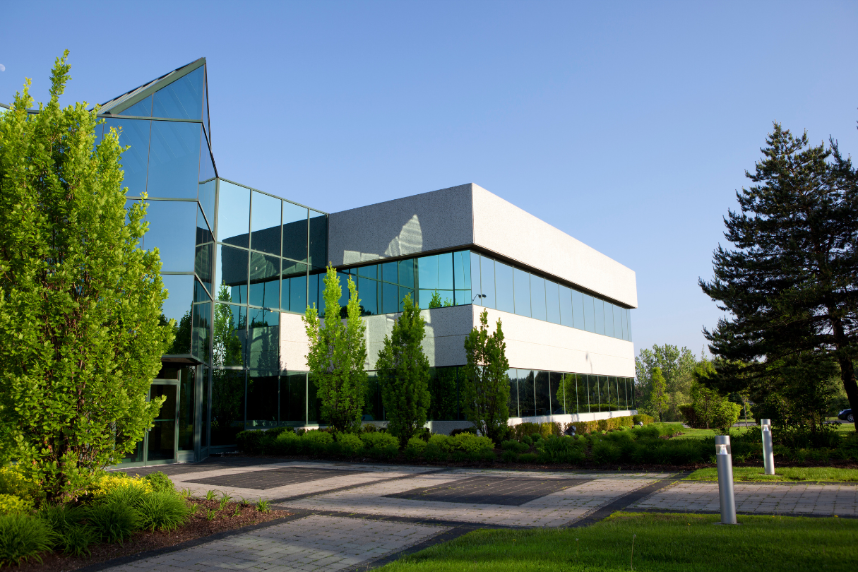 A large building with a lot of windows and trees in front of it