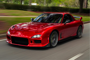 A car with a broken windshield is parked on the side of the road.