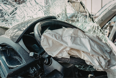 A family is sitting in the back seat of a car.