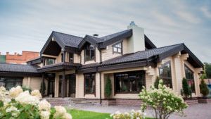 A large house with a lot of windows and flowers in front of it.