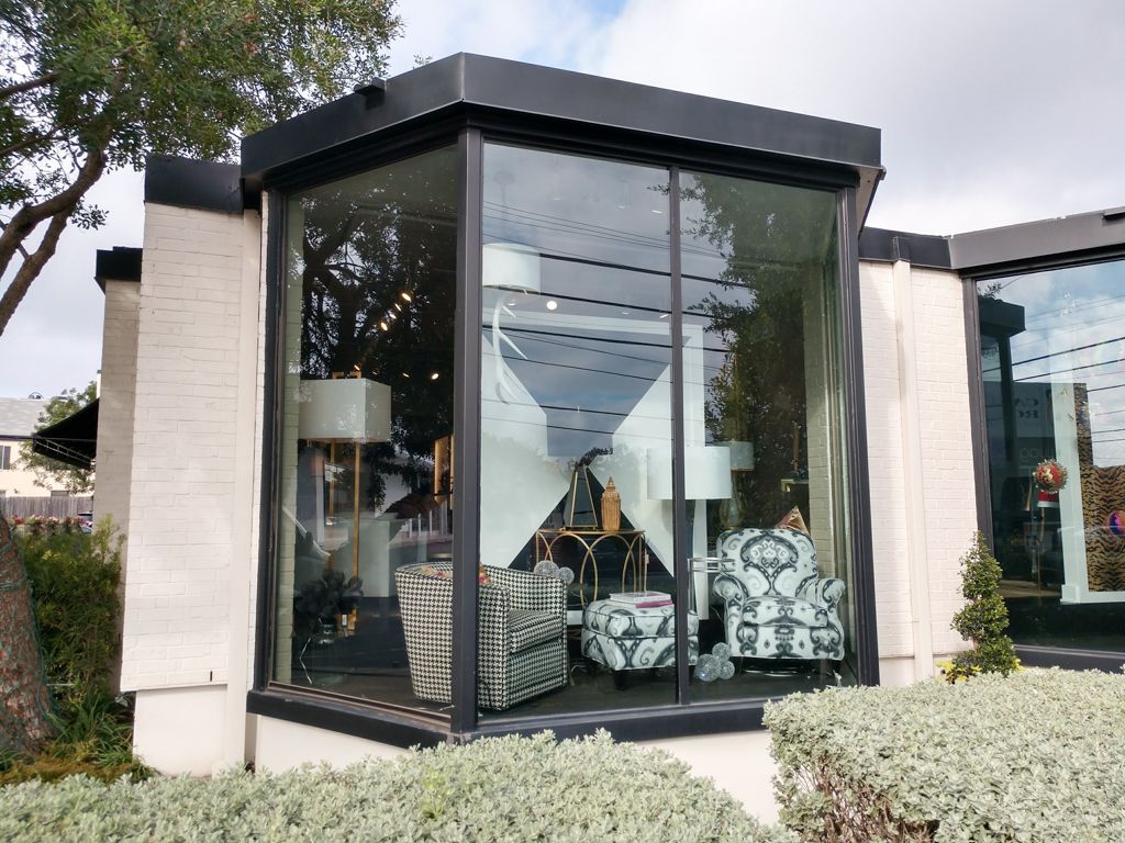 A house with a lot of windows and furniture in it