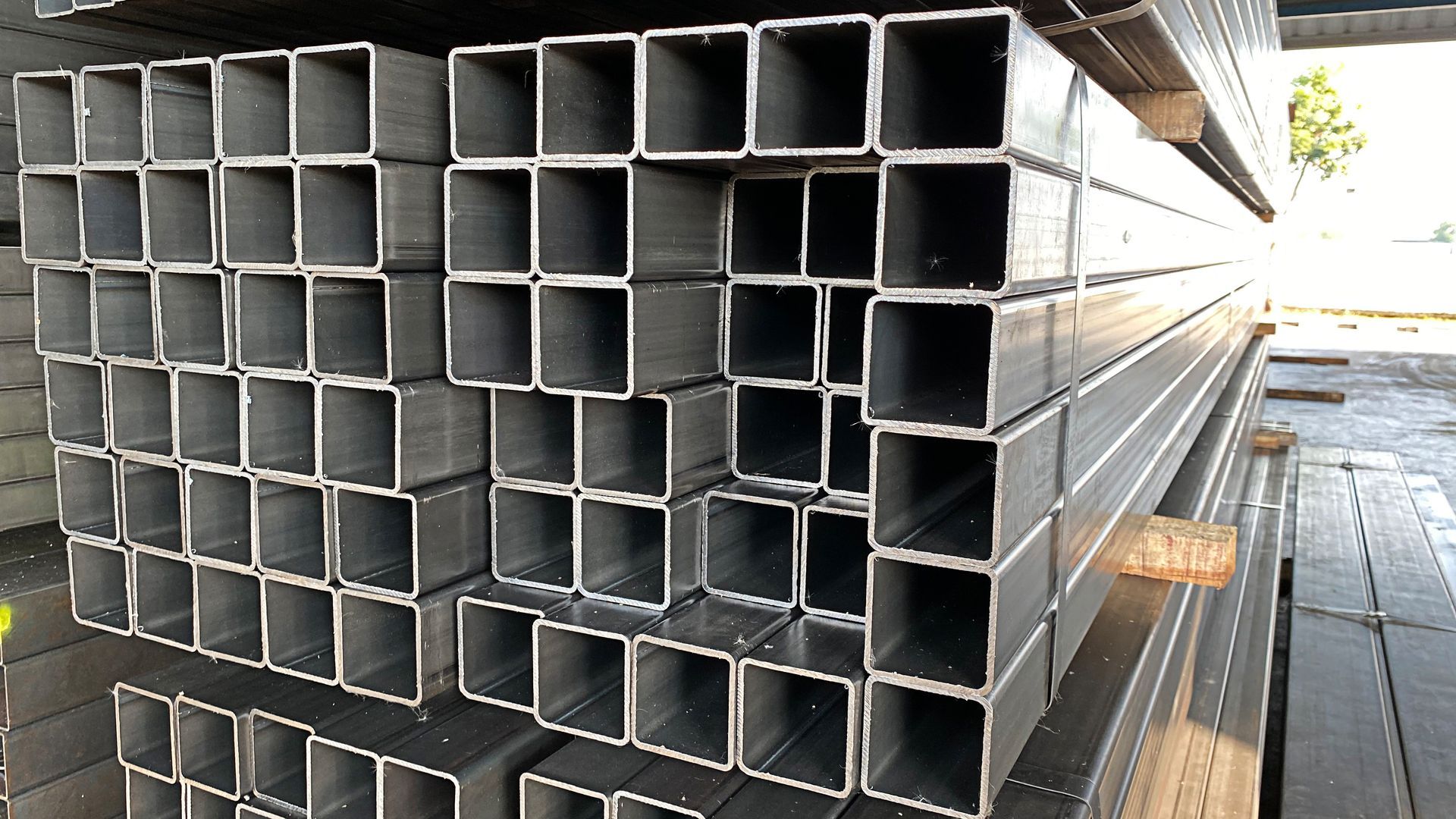 A pile of square steel pipes stacked on top of each other