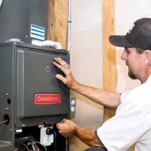 Doctor Cool - A man in a hat is working on a heating system.