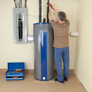 Doctor Cool - A man is fixing a water heater with a wrench