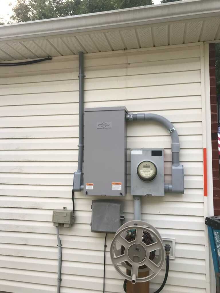 There is a meter on the side of a house.