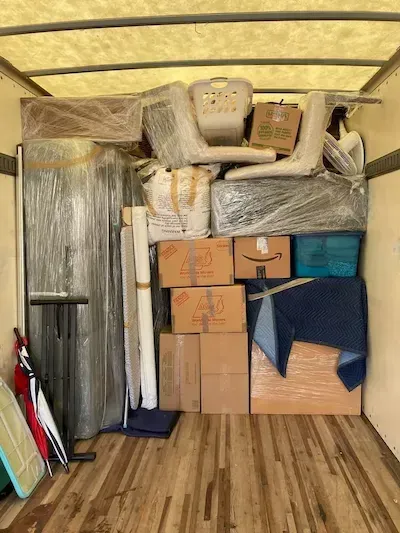 moving boxes and furniture are packed in a container