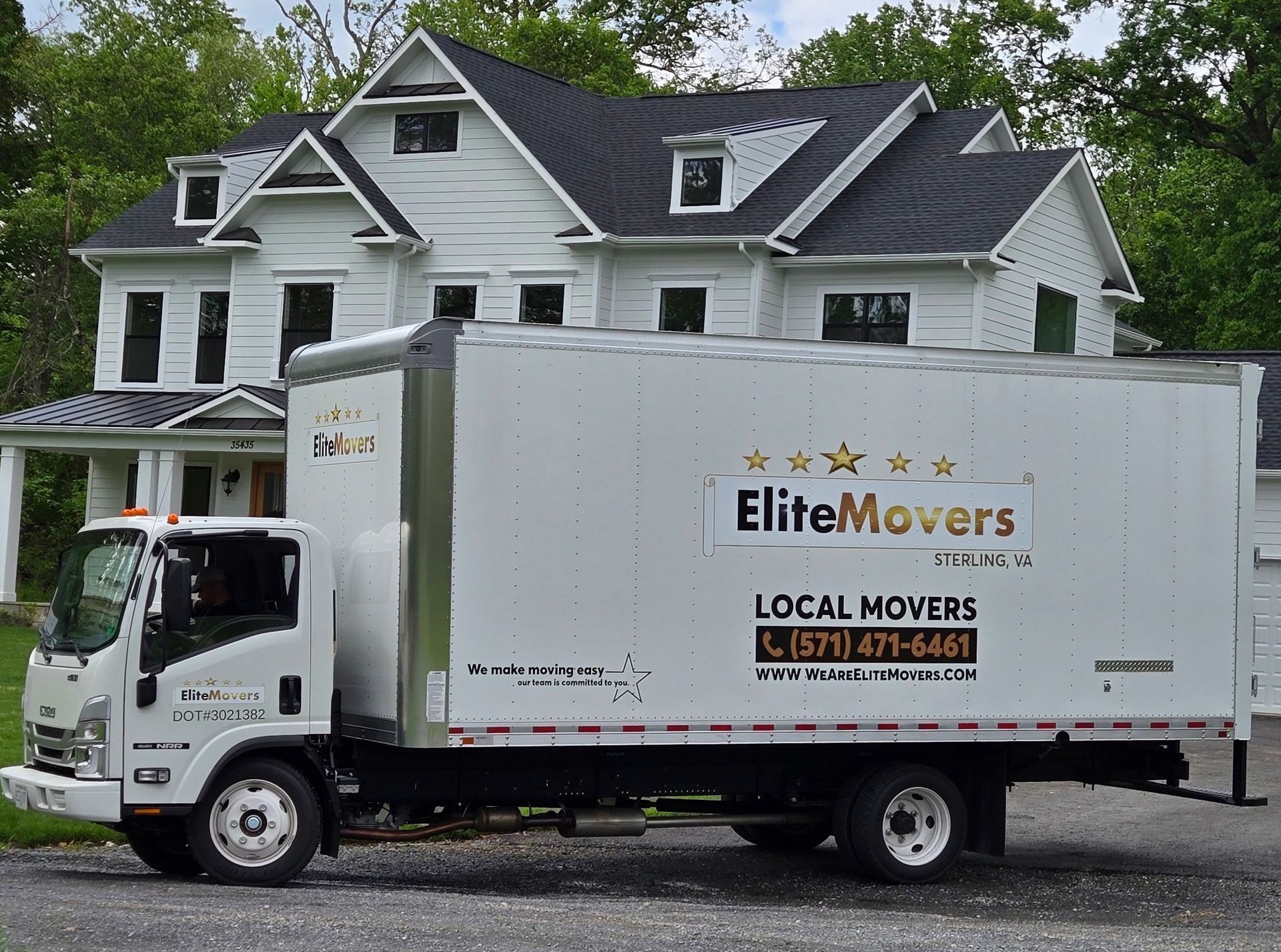 moving truck is parked in the driveway