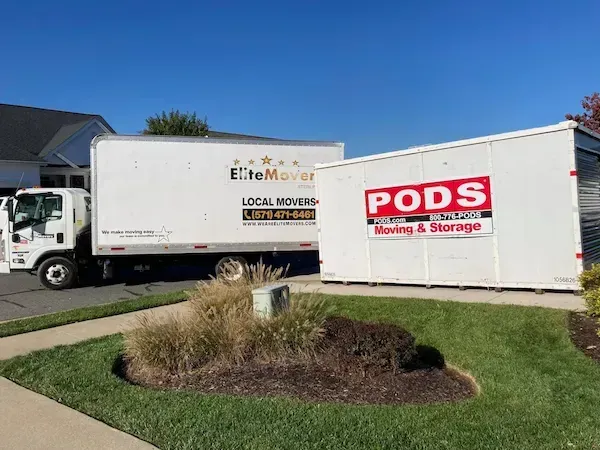 a white truck is parked behind a container