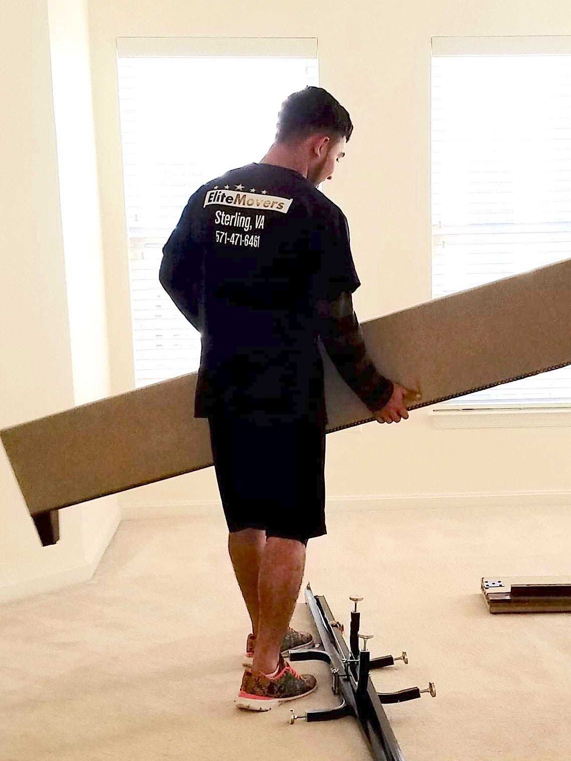 a employee is holding bed frame